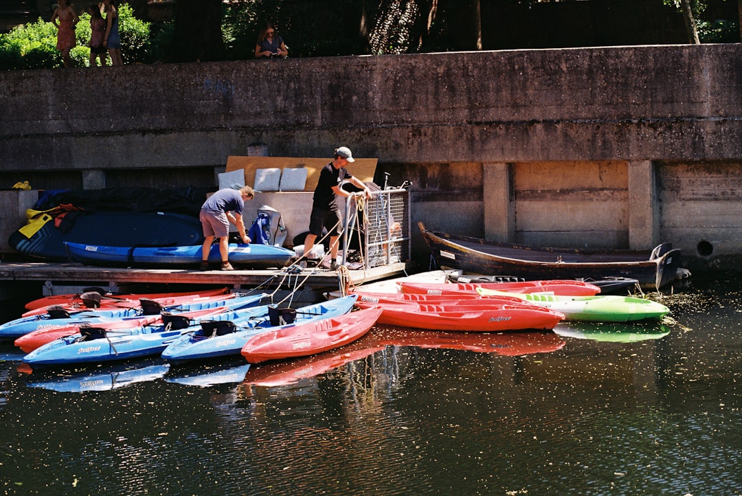 Colorful kayaks lined up at a waterside dock, ready for a guided tour
