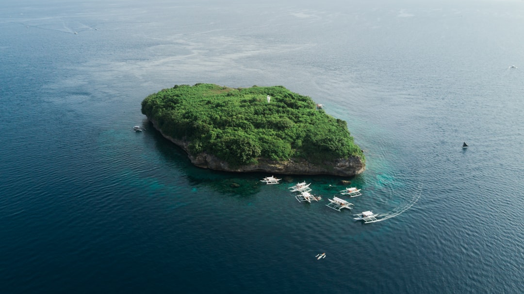 Aerial view of a lush green island in Casco Bay surrounded by turquoise water